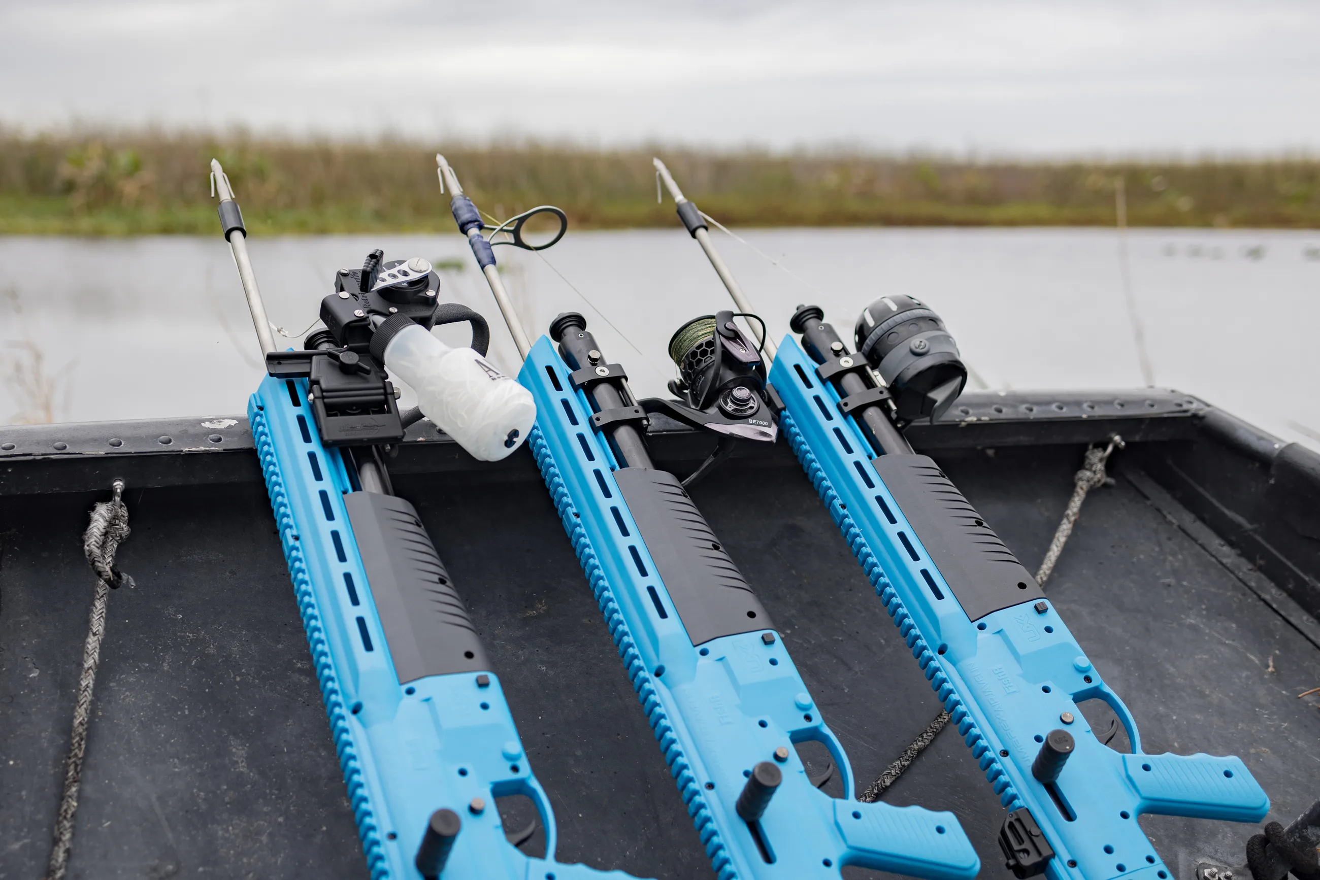 Three Umarex FISHRS with bowfishing arrows lined up on a boat bow
